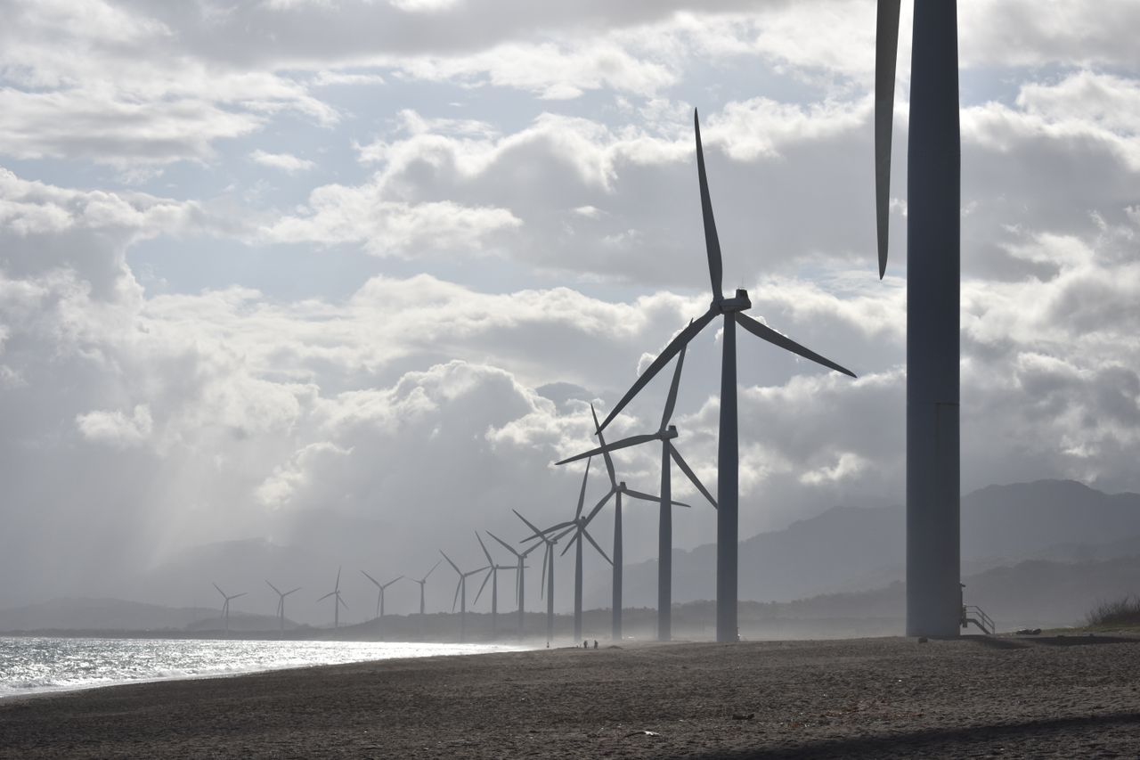 The Art of Drawing Readers In: Your attractive post title goes here A row of wind turbines along a cloudy beach shoreline in Vigan City, Philippines.