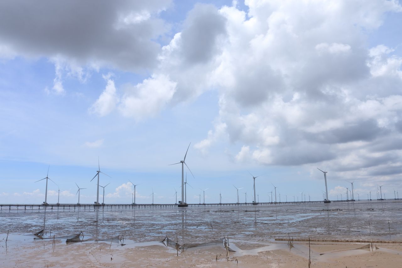 Crafting Captivating Headlines: Your awesome post title goes here Wind turbines on Vietnam coast under bright blue skies and fluffy clouds.